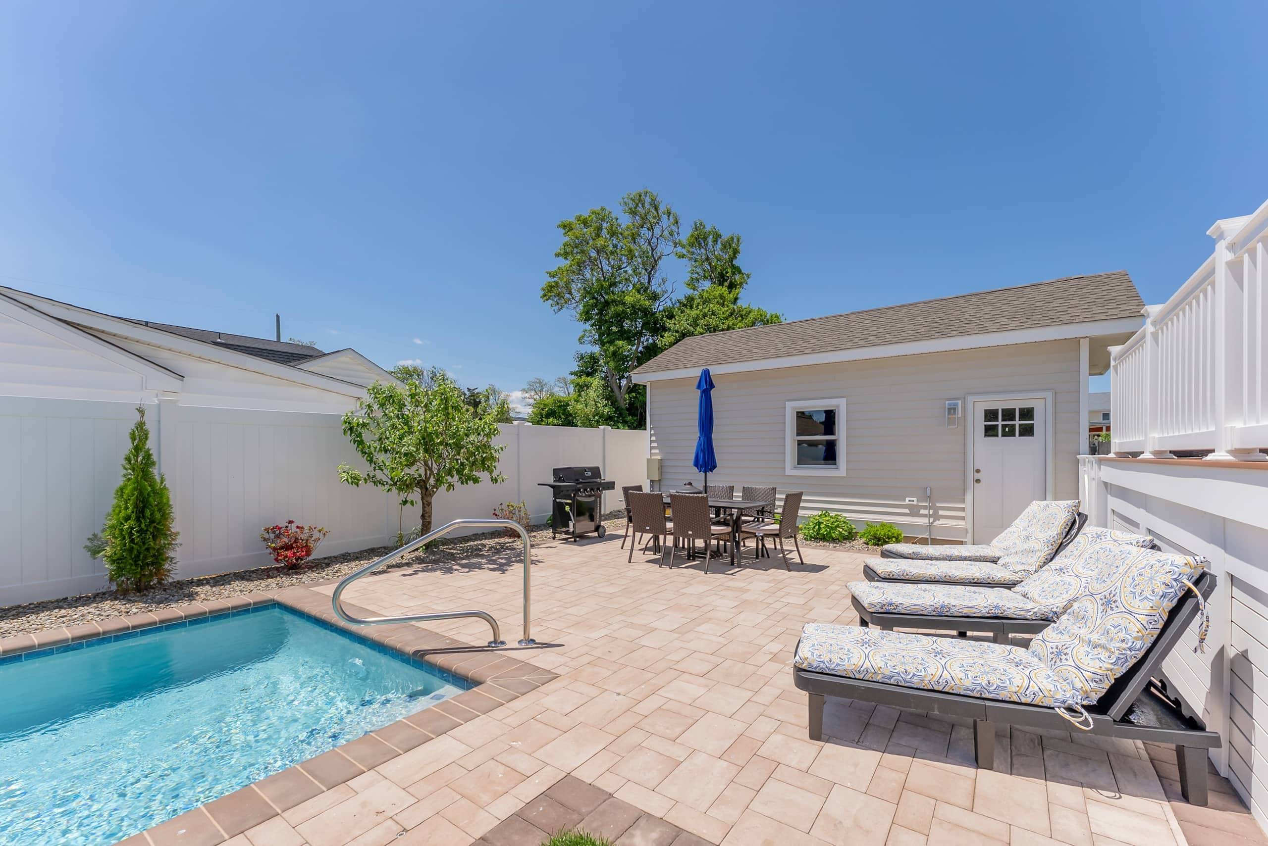 Lounge chairs and the pool at The Delford, seen from the deck
